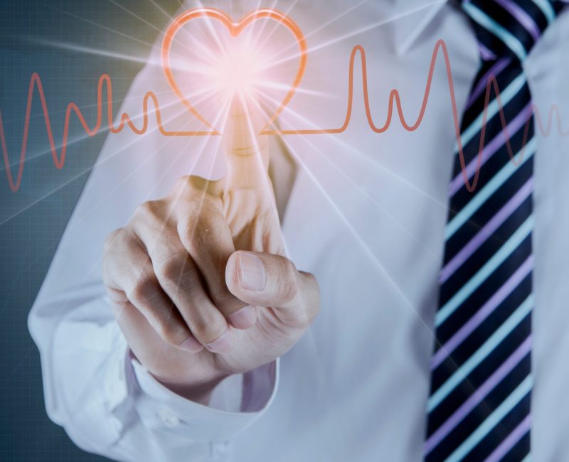 Businessman hand touch the heart pulse on futuristtic interface