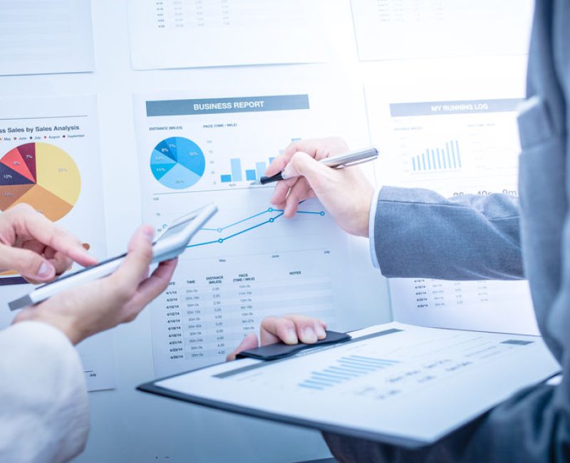 Business people discussing the charts and graphs showing the res Business people discussing the charts and graphs showing the results of their successful teamwork